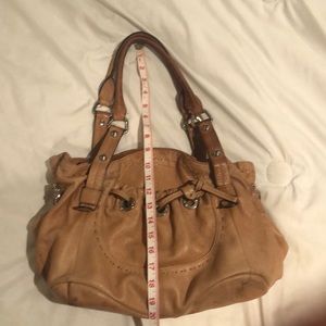 B. Makowsky tan purse with leopard interior